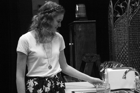 Sophomore actress Miranda Pizer having a moment to herself on stage while preparing the set.