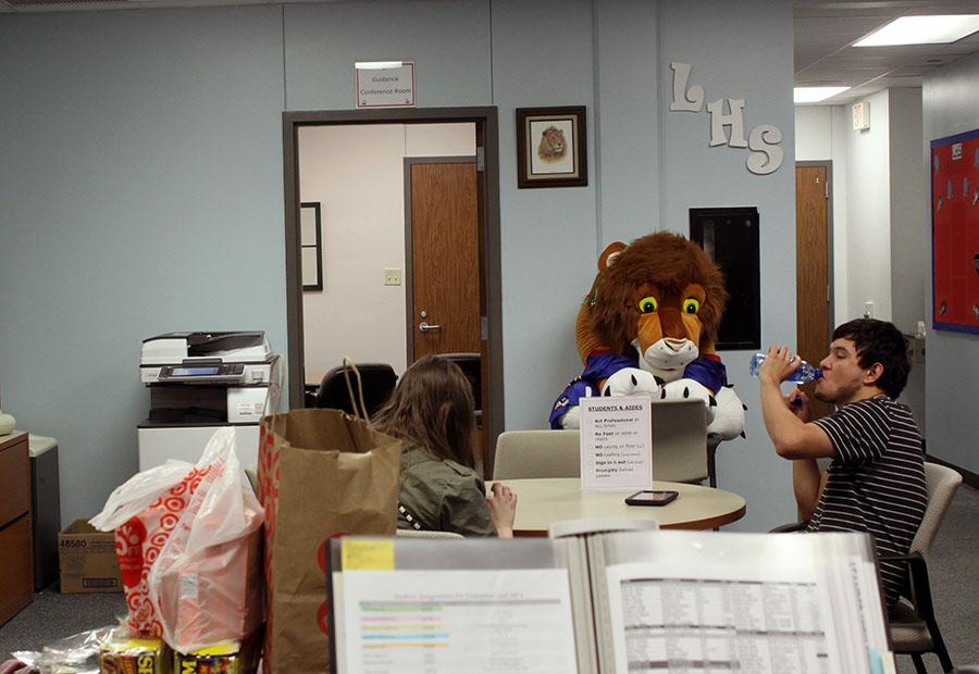 Two office aids sitting at their assigned table in the councilors office. The school cut backs would make all aid periods look similar to this, only two students at a time.