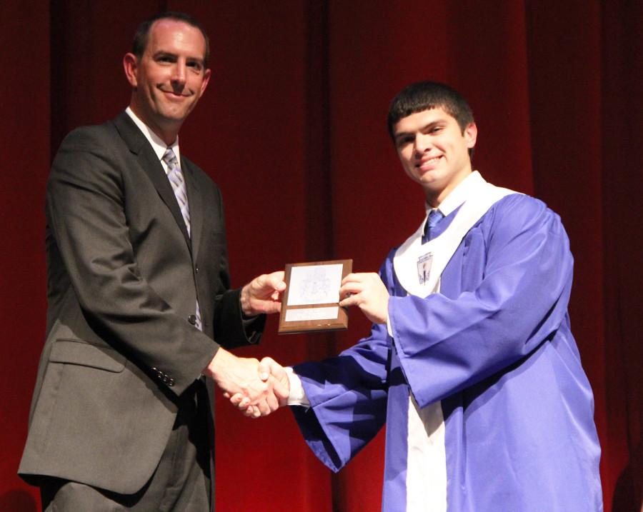 Shewmaker receives his award from Brad Mansfield for being ranked fourth in his class.