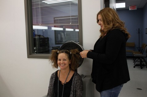 Mrs. Shaw gets her hair done by Mrs. Lozano, the cosmetology teacher