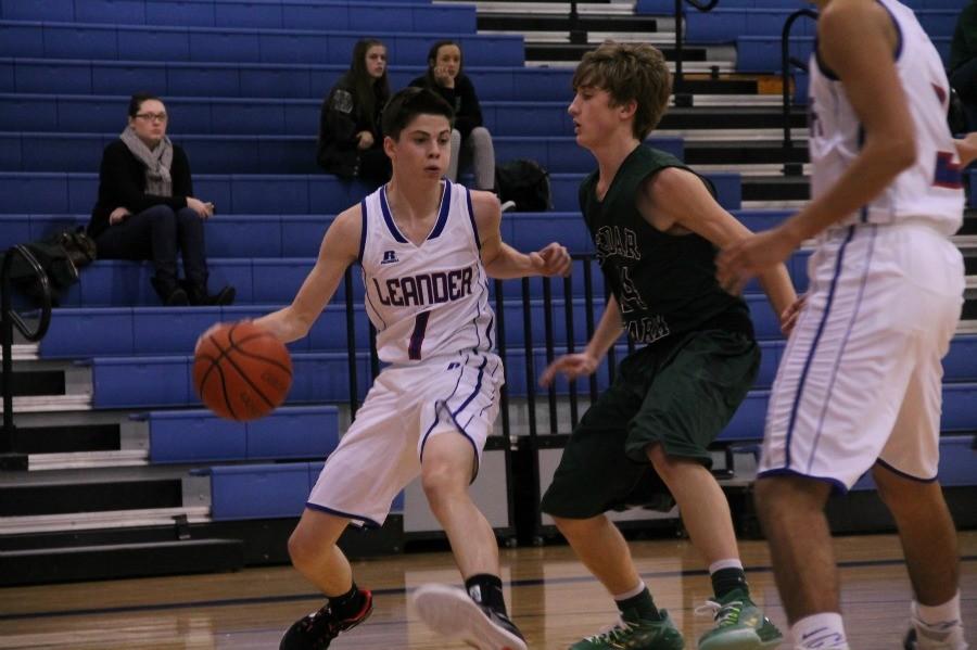 Sophomore Cody Bayer dribbles down the court