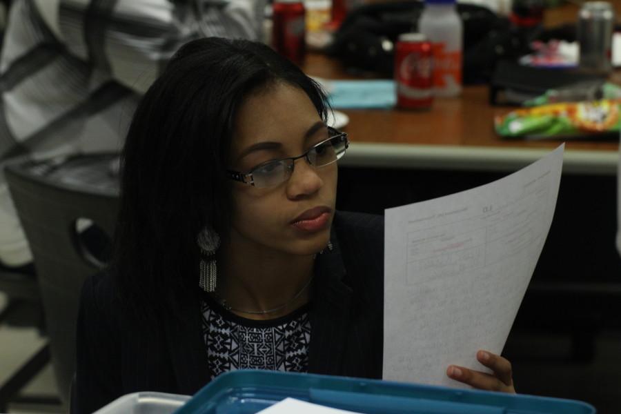 Senior Shekhiynah Larks studies notes before competiting in Lincoln-Douglas (LD) debate.