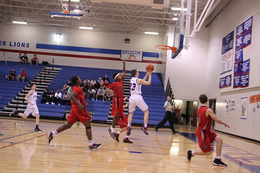 Sophomore Dominique Sewell shooting towards the basket.