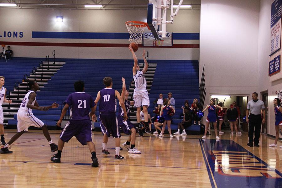 Sophomore+Cody+Bayer+scoring+a+basket.