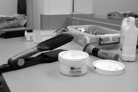 Dressing room counter cluttered in different beauty products to assist the actors. Most actors need make-up so the bright stage lights don't drown out their face.