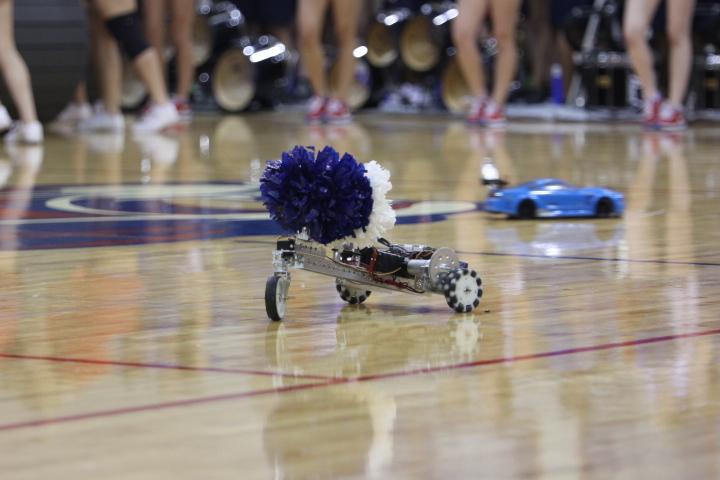 While waiting for competition to start, students built and controlled a pom-pom toting robot. They displayed it during the homecoming pep rally along with a remote controlled car.
