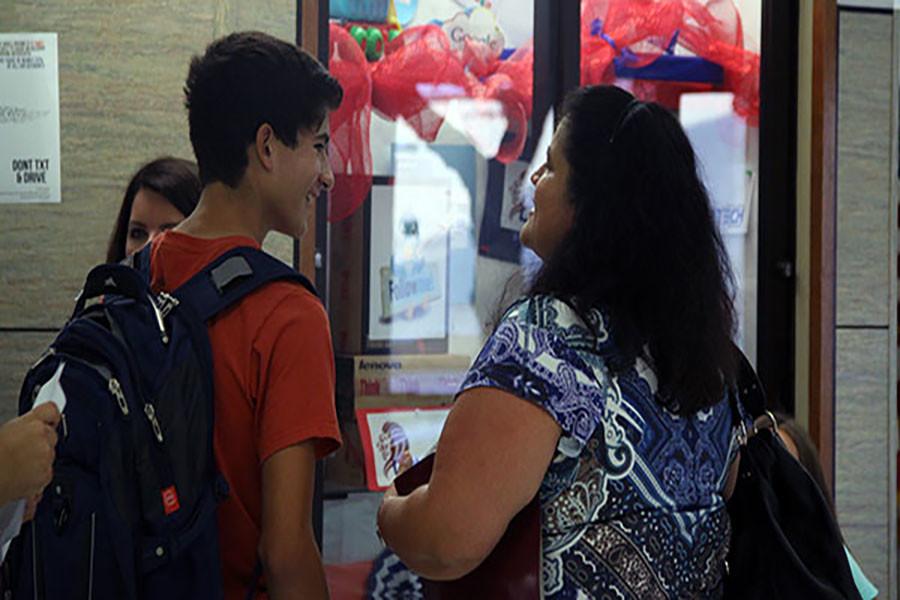 A student and his parent in front of the library at this years open house. Parents and their children often go to open house to look at clubs, organizations, and other information.