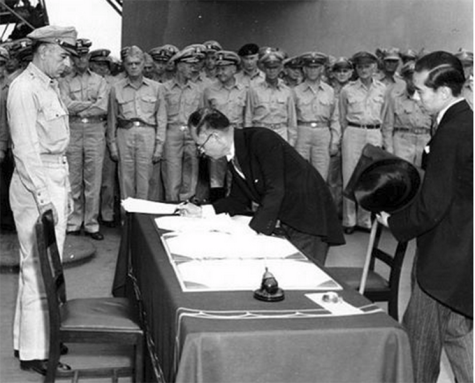 Japanese official signs the surrender papers on the USS Missouri on September 2, 1945.