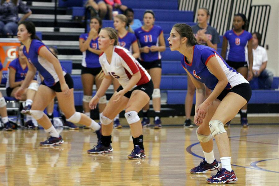 Sophomores Pilar Gonzaba and Skyllar Duncan and senior Sierra Stevenson line up to wait for the serve in the second set against Cedar Park. The final outcome was 3-1, Timberwolves over Leander.