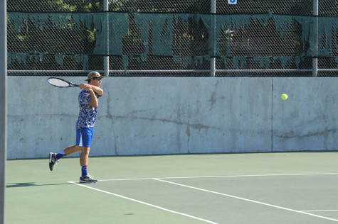 Senior Ricardo Acosta hitting the ball back to the opposing team. They would be eliminated from district on October 6.