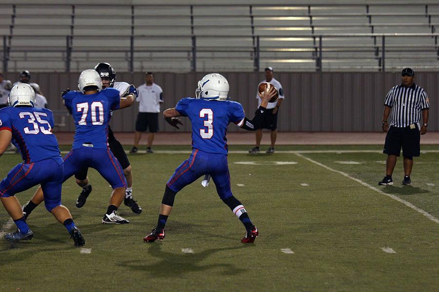 Quarterback Kyle Irlbeck sets up to throw a pass. He connected with his receiver for a touchdown later in the game.