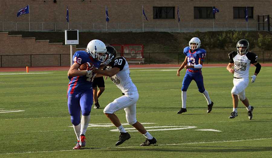 Sophomore Ivan Ayub catching a pass from sophomore Josh Rude. The Red team is 4-4 this season so far with two games left.