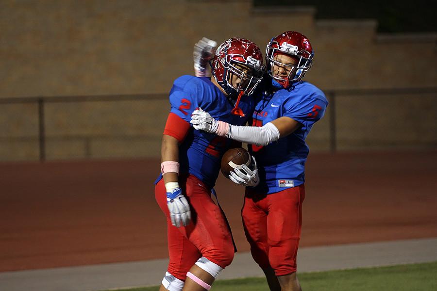 Sophomore Alex Williams and senior Isaiah Turner celebrating after Williams scored a touchdown off an interception. This would be the final score for the Lions in the game.