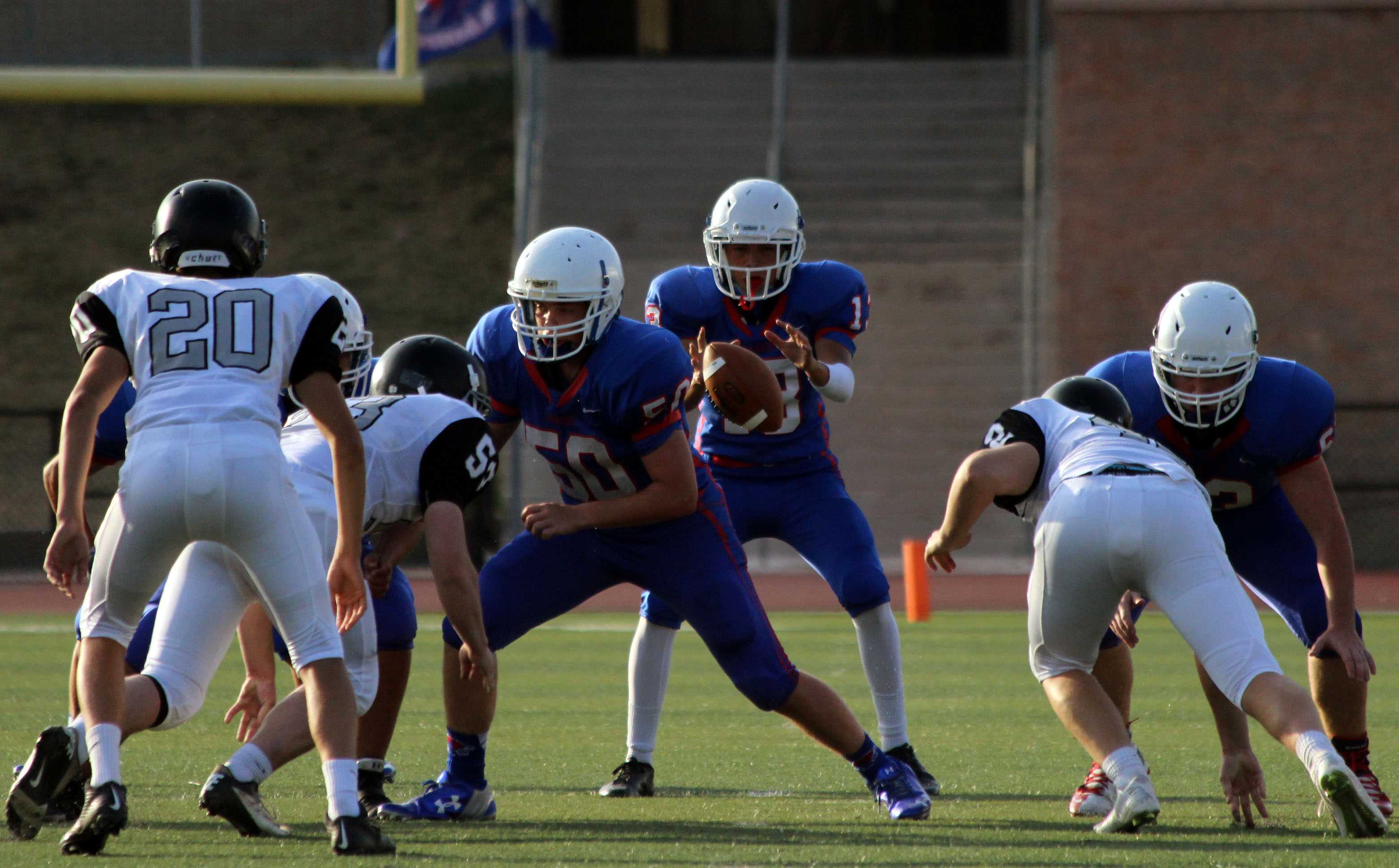 Sophomore Red quarterback Josh Rude getting the ball snapped to him. Rude played quarterback for the first time this year as he usually plays tight end.