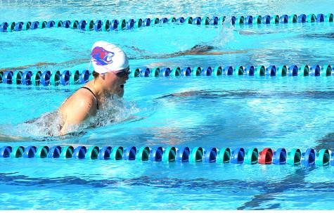 A swimmer swims breaststroke. Their first victory of the season was against Rouse/Meridian.