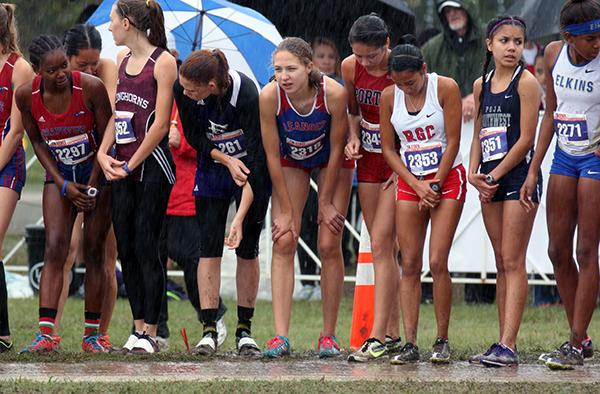 Senior Claire Crone waits at the starting line while rain suddenly begins to pour around her. Crone placed 52nd at the meet.