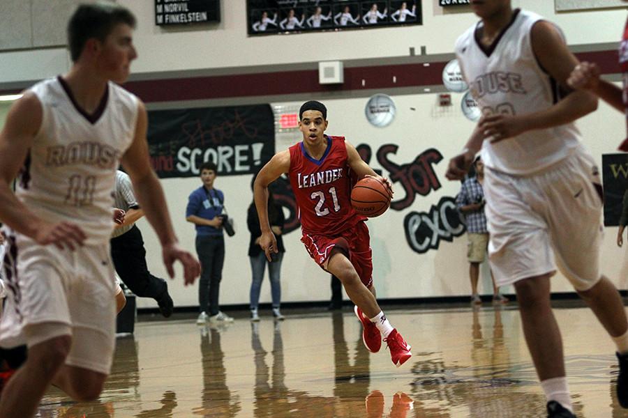 Junior Kobe Thompson dribbling down the court against Rouse. Thompson finished with 15 total points in the game.