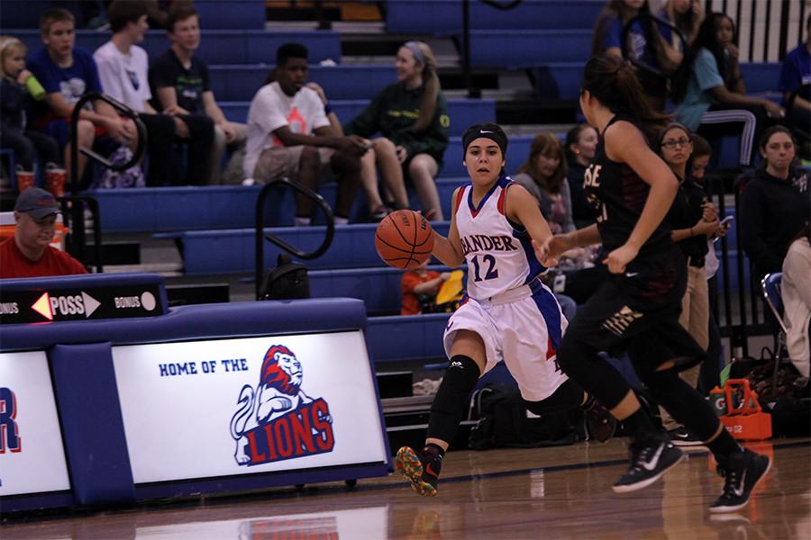 Sophomore Madison Lawton dribbling down the court. Lawton scored six points in the game.