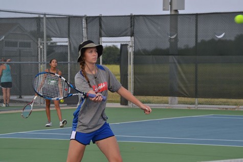 Madison Flesner hitting a tennis ball back to the opposing side. They would win 8-2.