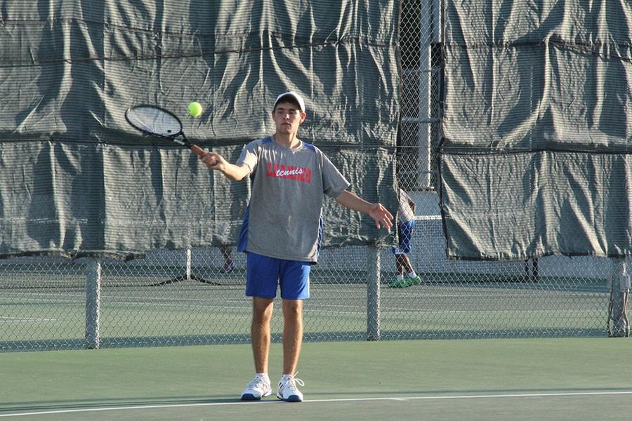 One of the doubles partners senior Luis Farias, hitting a ball towards an opponent. They won the consolation boys doubles 9-7.