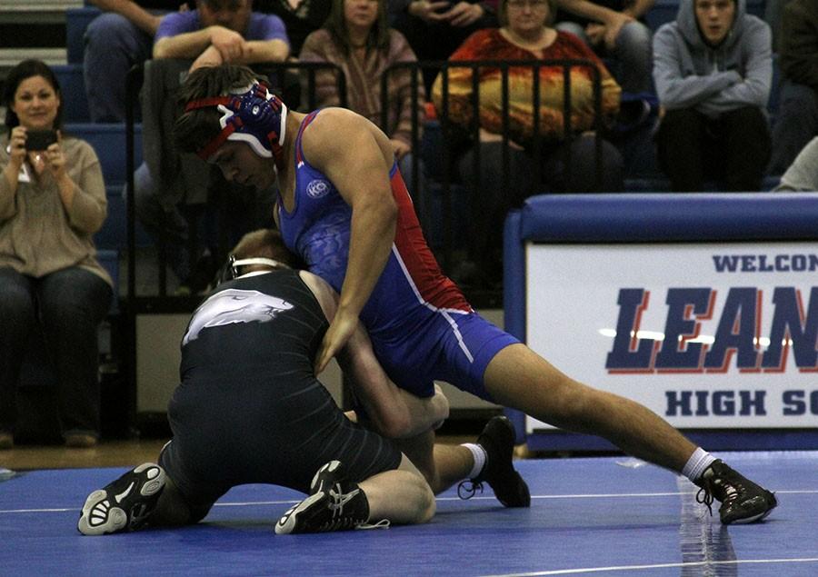 Senior Ricky Smith wrestles against his opponent. The Lions won in this meet.
