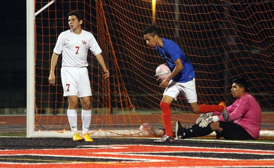 Senior Ruben Gonzales grabs the ball out of the net after scoring with a minute left. However, the time ran out before they could tie it up and they lost 2-1.