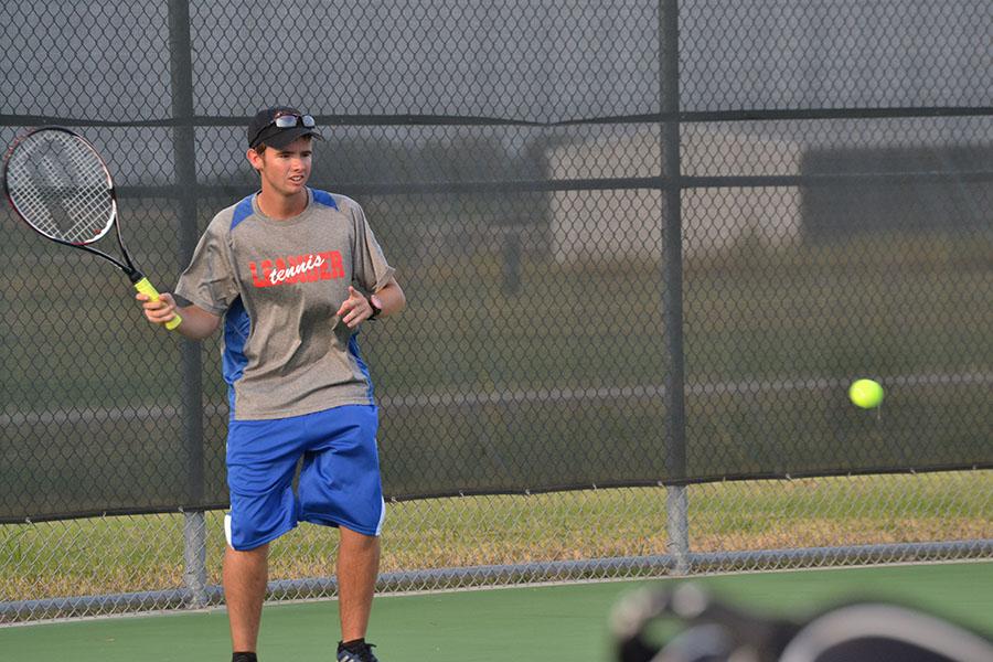 Russel Thomas engaged in a match against an opponent. The Girls' Doubles and Mixed Doubles walked away victories this week.