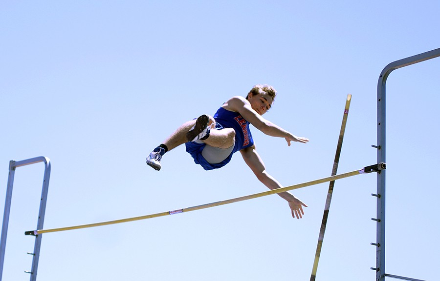 Junior Derek Voss competing in pole vault. His best jump to win first was 13 feet and 2 inches.