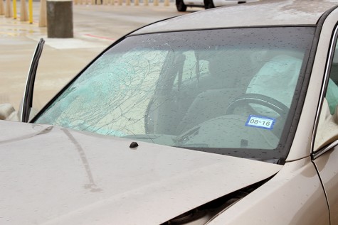 The windshield of the car is cracked from impact. On the inside of the car, one would see a beer box.