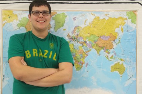 Senior Rafael Schoellmann behind a world map. He wishes to visit Nepal later in his life. 