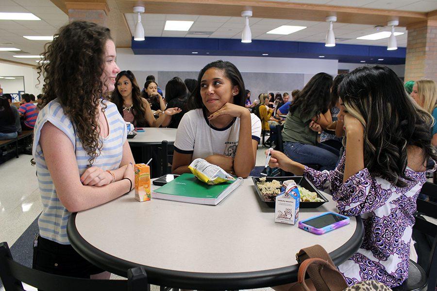 Students enjoy lunch in the cafe area. 