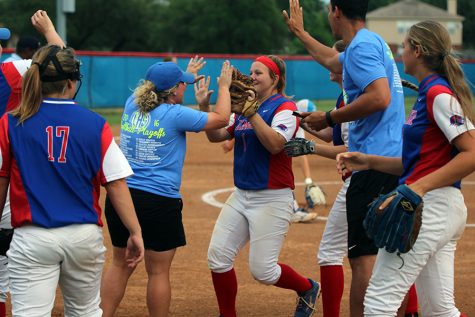 Head Coach Kendall Driver and freshman Haley Henderson celebrating after Henderson catches a fly ball.