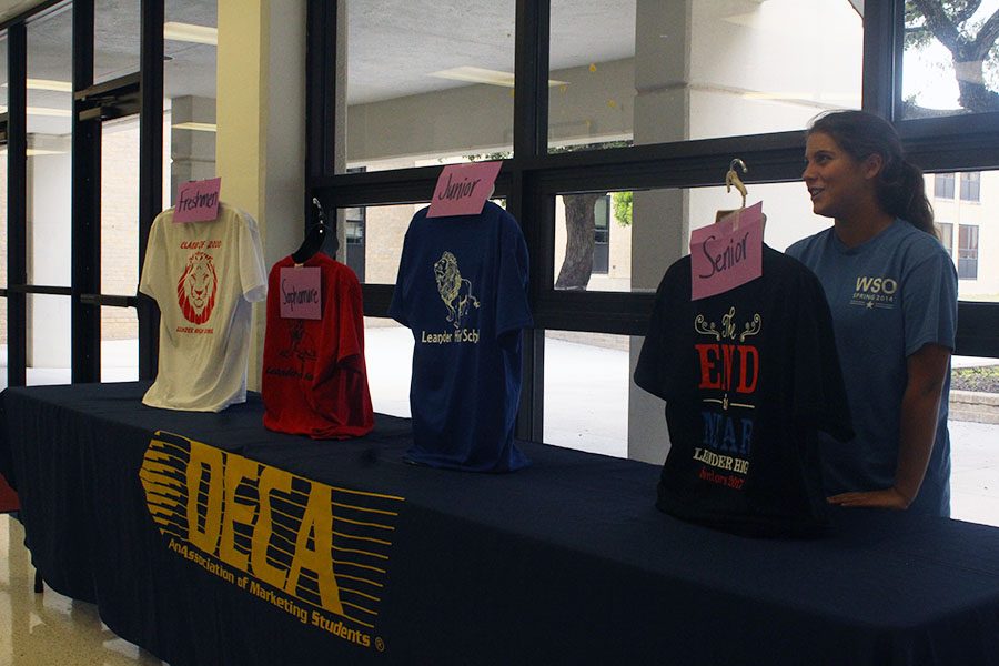 Senior Emilie Scanlon advertising shirt sales at the DECA table during lunch. All shirts are being sold for $15.