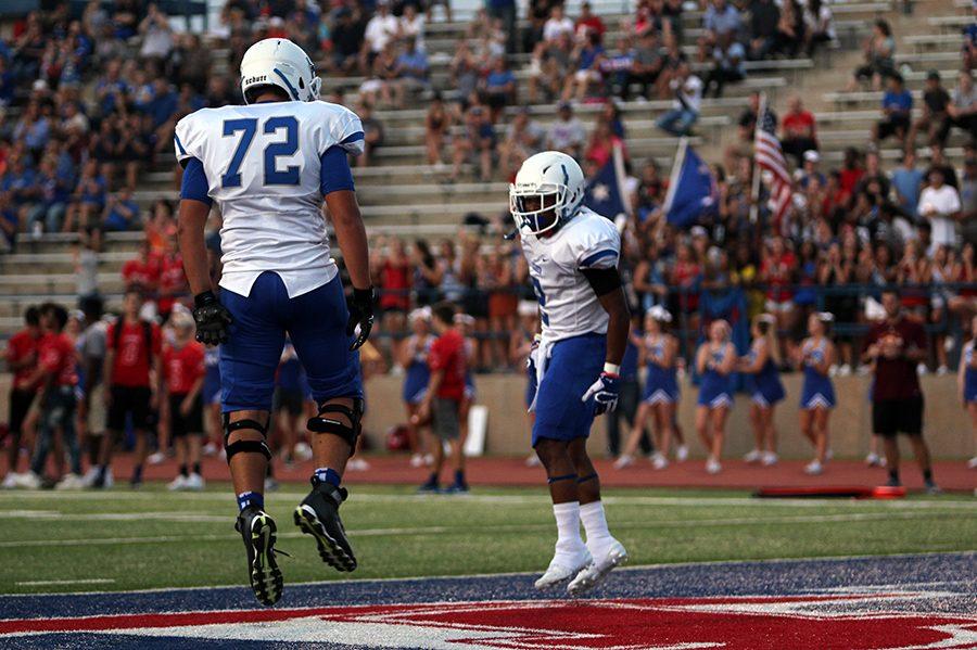 Senior Jai Garcia and junior Josh Long celebrate Garcia's touchdown. The touchdown tied the score at 7-7.