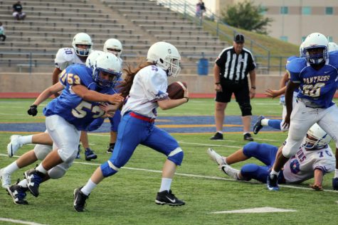 Freshman Staci Laramore runs the ball during the game against the Pflugerville Panthers. She is the only girl on the team of any level of football this year.