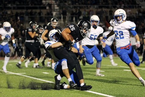 Junior Riley Harkleroad tackles a Vandegrift player. He had nine total tackles in the game.