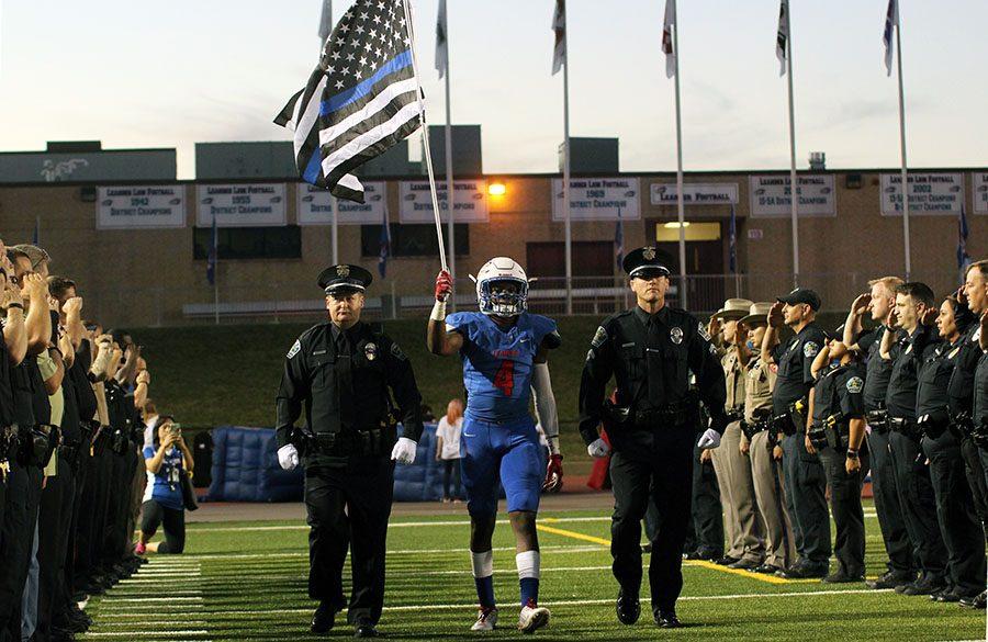 Senior Mati Abdul-Khaliq walks out during a tribute for his father Amir Abdul-Khaliq. It was held before the game.