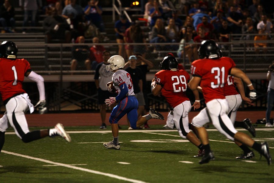 Sophomore running back Adison Larue rushes past the Vista line to score his first touchdown of the night. Larue scored both of the Lion touchdowns.
