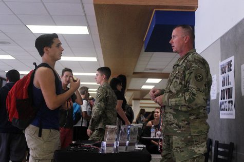 Staff Sergeant Munger talks to a student during lunch.  Munger is a recruiter for the National Guard and has also been in combat in Afghanistan.