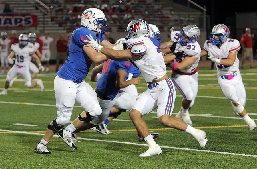 A Lion defender blocks a Westlake player. The Chaps offense scored 41 total points.