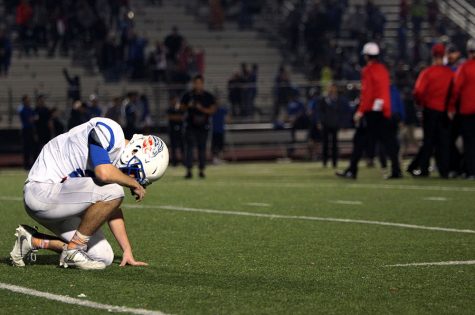 A Leander player kneels in disappointment after the game. The Lions did not advance to playoffs due to their loss. 