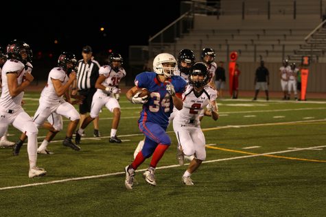 Sophomore running back Adison Larue breaks past the Lake Travis defensive line. Larue had his first scoreless game of the season against the Cavaliers.