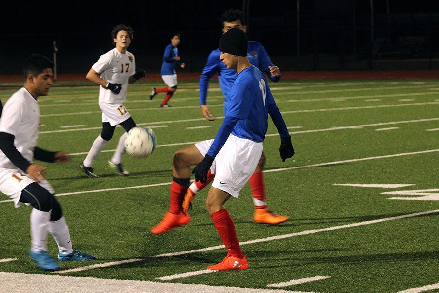 Sophomore Angel Ruiz flicks the ball past a Rouse defender. They lost this game 3-1.
