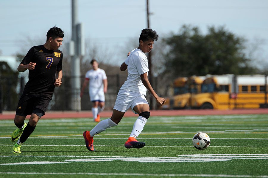 A Leander midfielder takes on a Marble Falls defender. The Lions lost 2-0 in this game.