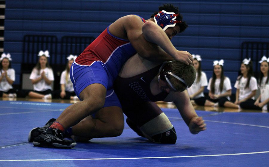 A wrestler competes during Leander's match during senior night.  They won this meet by a score of 67-6.