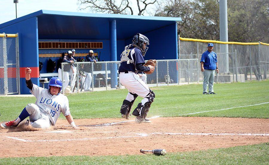 Senior Clay Martin slides into home to score against St. Dominics. They went on to win 13-3. 
