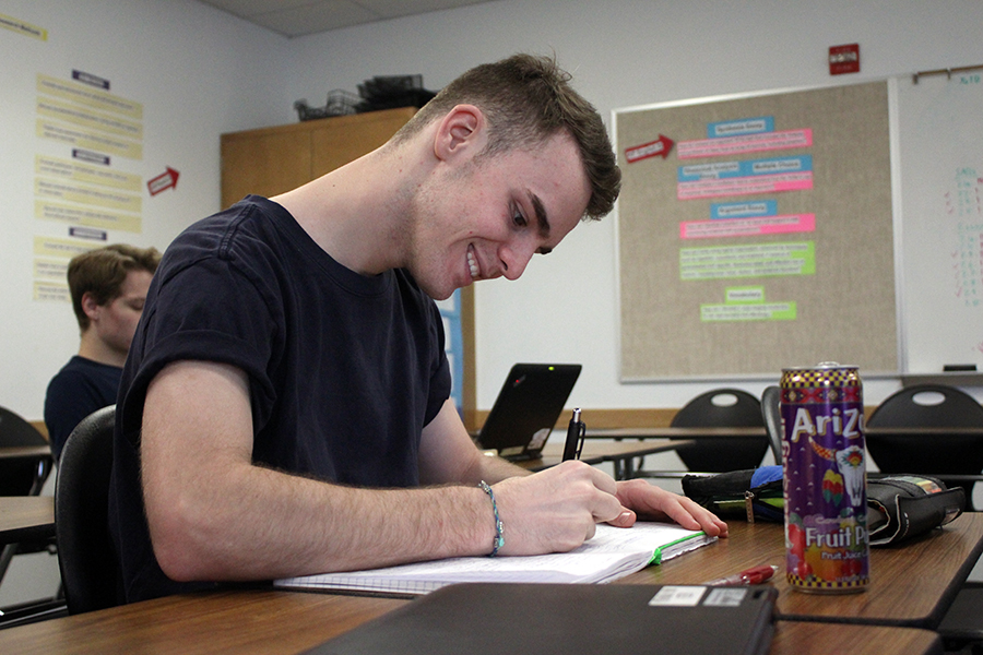 Senior Patrick Wilbanks takes notes during a IB Psychology class. The main difference between IB and AP is that IB is more of a program while AP is a set of individual classes that don’t correlate with each other.