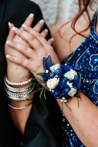 Corsages and Boutonnieres  come from a tradition when flowers were worn to make one smell nice while dancing with their partner. Today, they are used as accessories to go with the dress or tuxedo. 