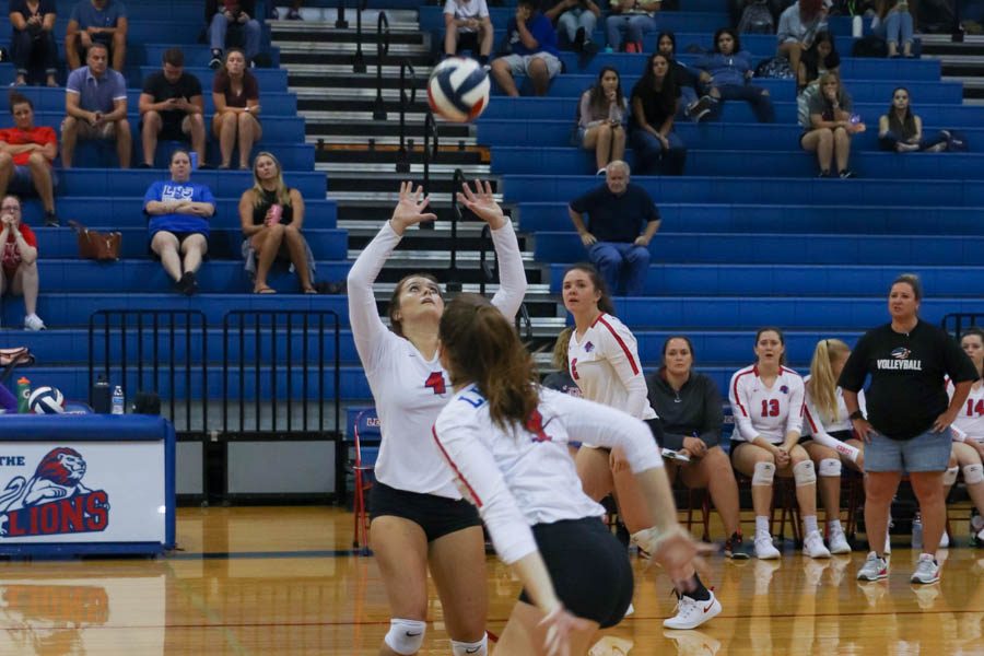 On Aug. 23, junior Callie Carrejo sets the volleyball to junior Presley Catalina. The lions won against Warren 2-0. 