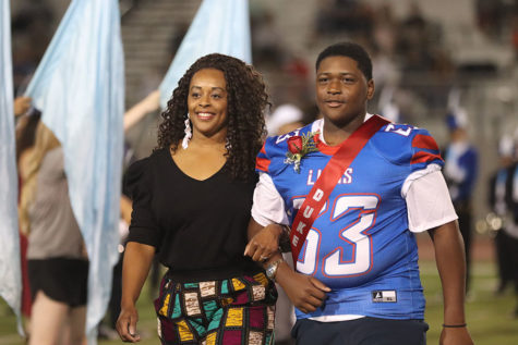 Freshman Dayne Caldwell walking the field with his mom after being announced as Freshmen Duke